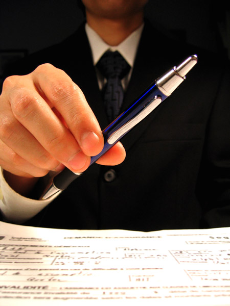 Man with contract and pen on sale of business escrow services